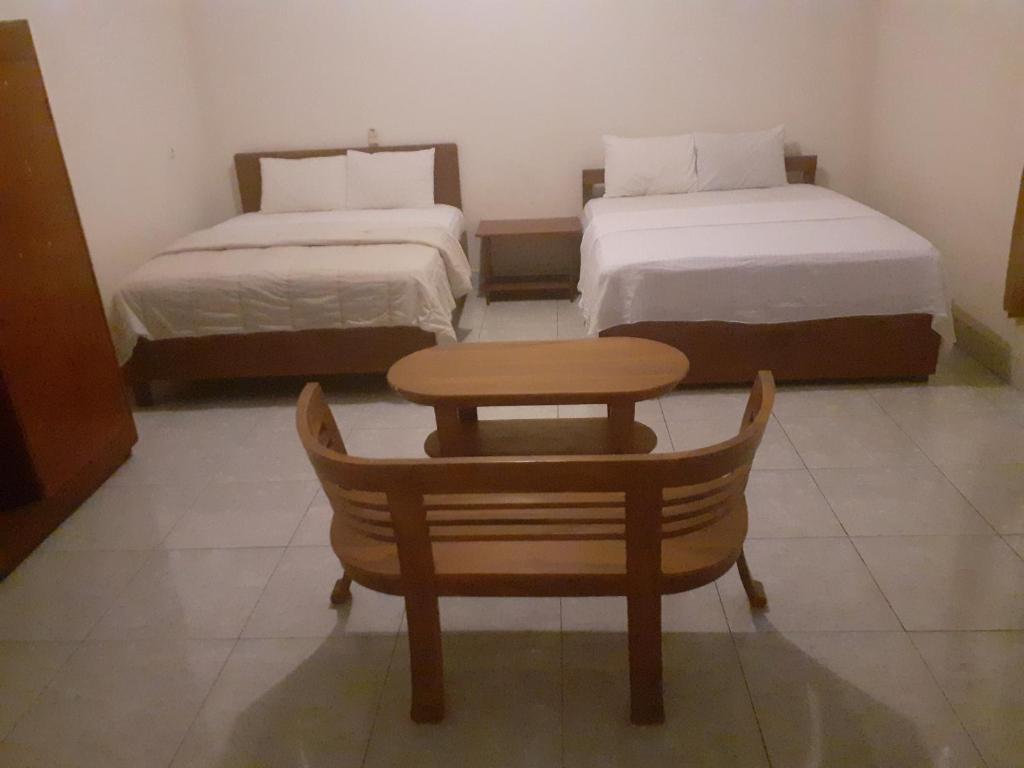 Postel nebo postele na pokoji v ubytování Sari Laut