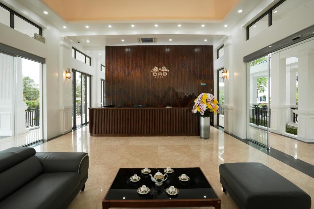 a living room with a couch and a table at DAD Resort Phú Quốc in Phú Quốc
