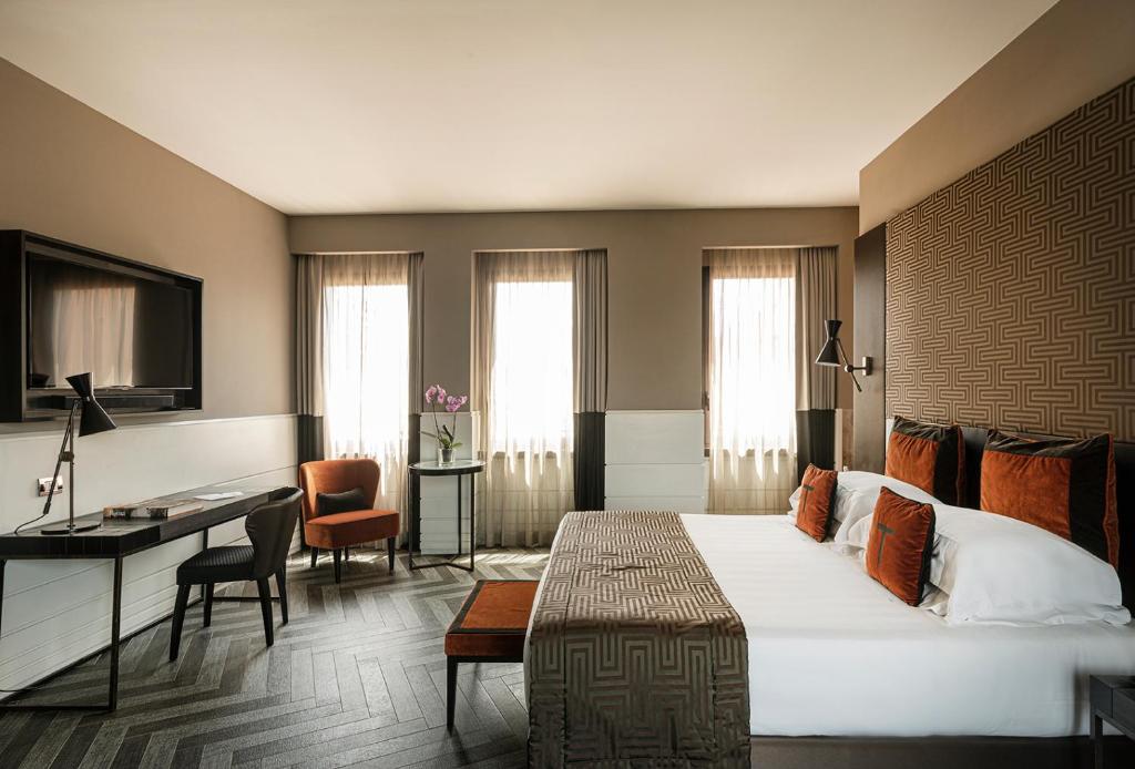 a hotel room with a large bed and a desk at The Tribune, part of JdV by Hyatt in Rome