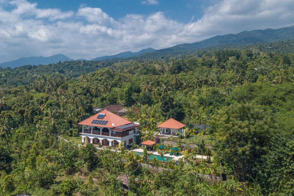 an aerial view of a house in the middle of a forest at Villa Mata Hari in Panji