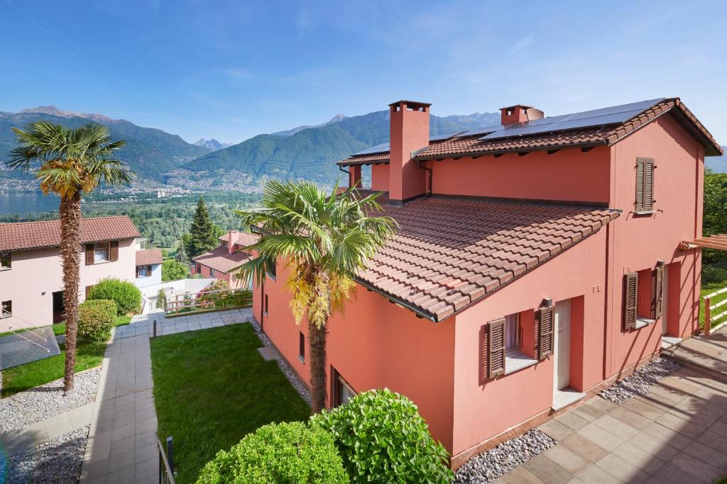 an aerial view of a house with palm trees at Reka-Ferienanlage Magadino in Magadino