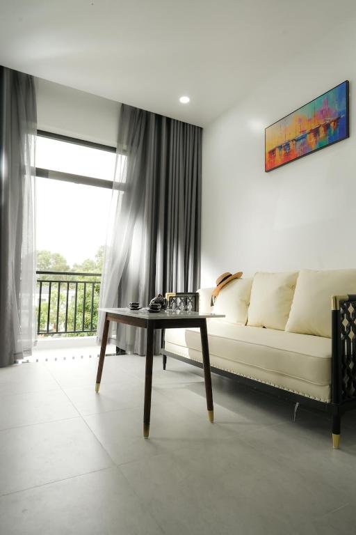 a living room with a couch and a table at DAD Resort Phú Quốc in Phú Quốc