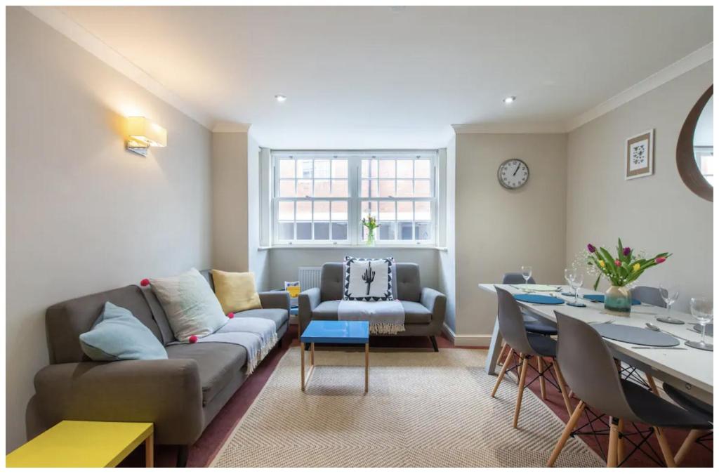 a living room with a couch and a table at Wells City Centre, Quiet Mews House, sleeps 6 in Wells