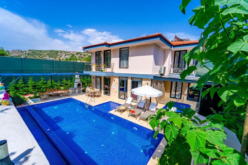 a villa with a swimming pool and a house at Villa Destan Patara in Gelemiş