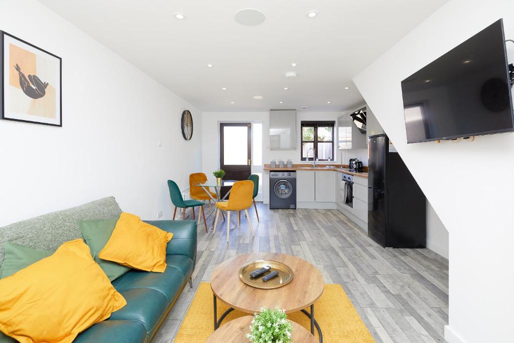 a living room with a couch and a table at Modern 2 Bed House Near Queens Medical Centre in Nottingham