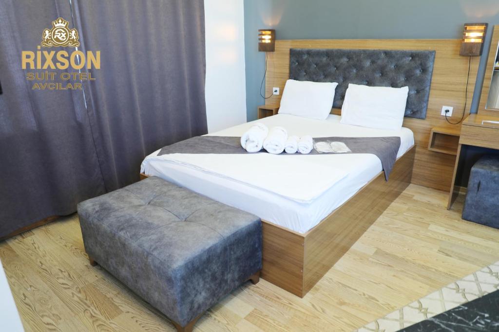 A bed or beds in a room at Rixson Otel