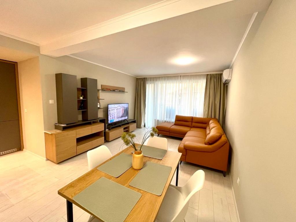 a living room with a table and a couch at RELAX Apartments in HASKOVO, Apt2 in Haskovo