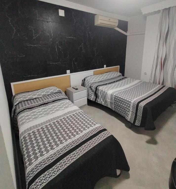 Postel nebo postele na pokoji v ubytování Hostal la Campana