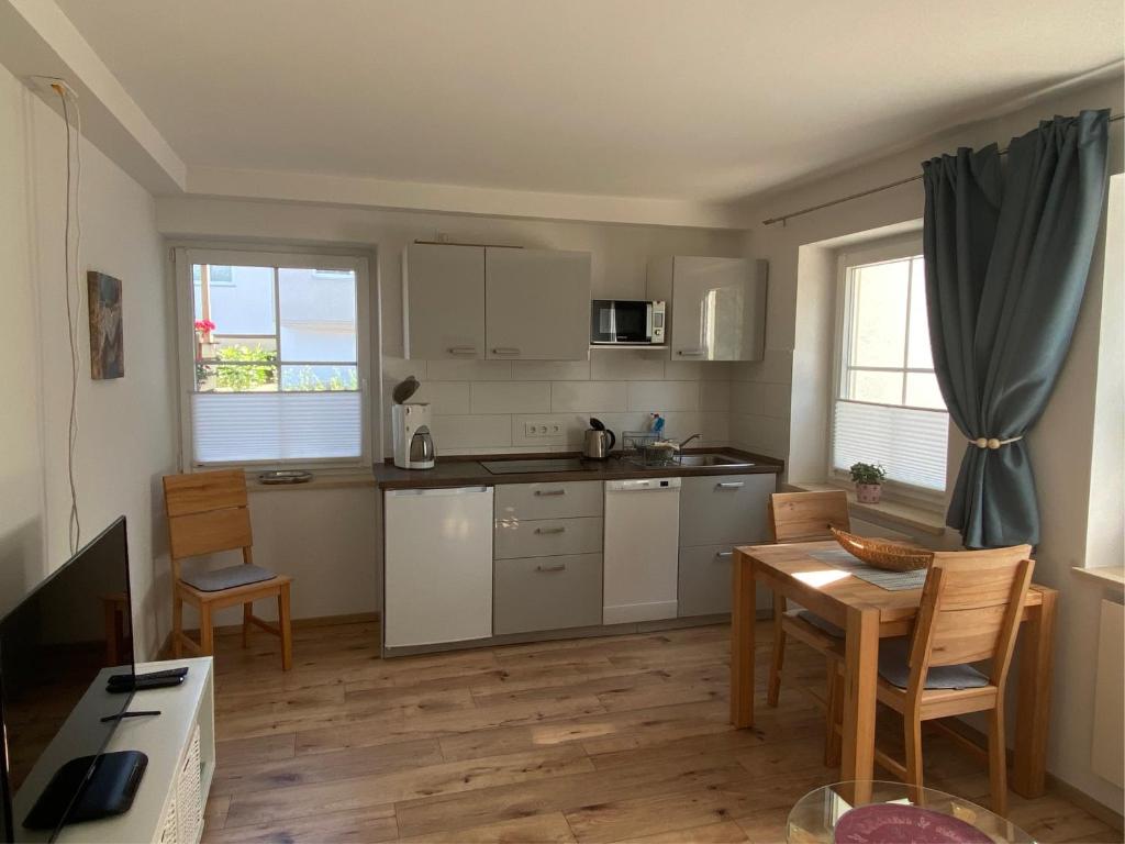 a kitchen with a table and a dining room at Heike & Günther Ferienwohnung in Seeg