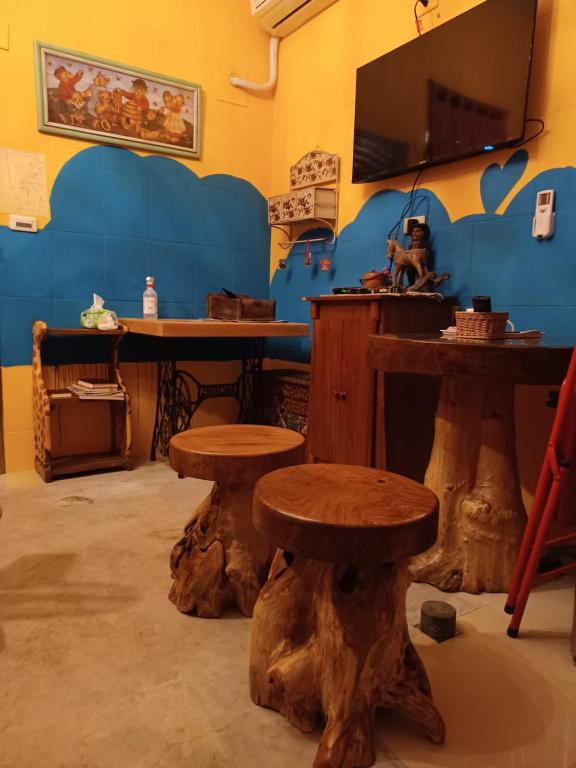 a room with a table and two wooden stools at Hualien Seaside B&amp;B in Hualien City