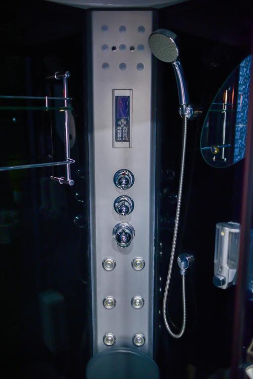 a bathroom with a shower with a shower head at Medius Park Apartment in Sandanski