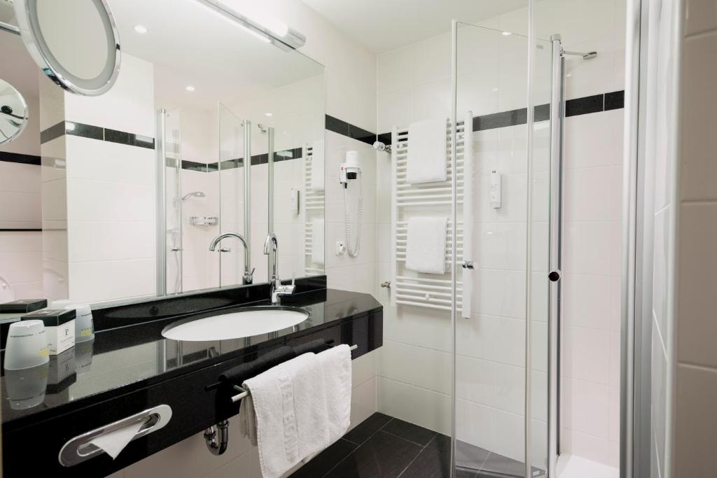 a bathroom with a sink and a shower at ACHAT Sternhotel Bonn in Bonn