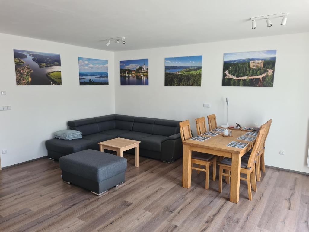 a living room with a couch and a table at Apartmán Kuba in Frymburk