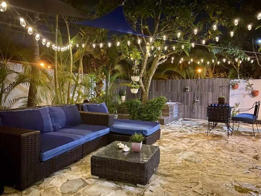 a patio with a couch and a table and lights at Casa con Parqueo Privado, Patio y Jacuzzi. in Santo Domingo