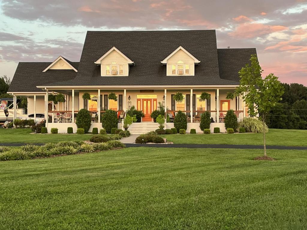 a large white house with a black roof at Barren Breeze Bed and Breakfast in Lucas