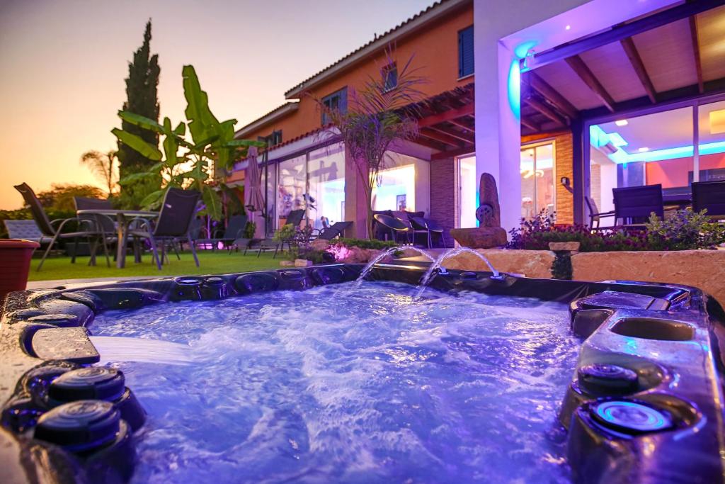 a hot tub in the backyard of a house at Luxury Marissa Villa in Chlorakas