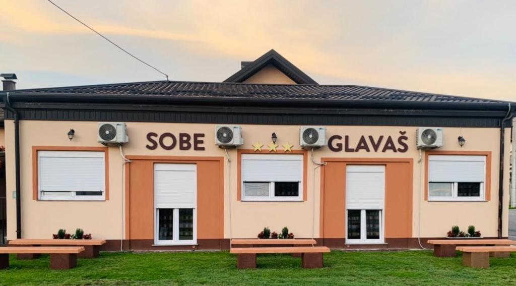 a building with benches in front of it at Sobe Glavaš in Garešnica