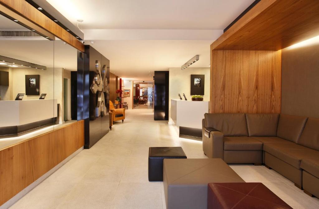 a living room with a couch and a table at Copa Sul Hotel in Rio de Janeiro