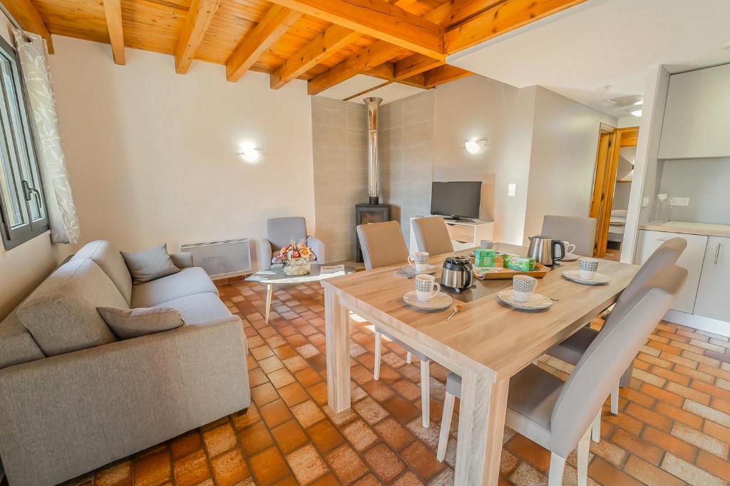 a living room with a table and a couch at Villages de Gîtes Le Pigeonnier in Le Malzieu-Ville