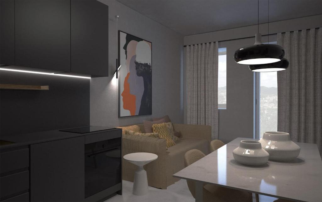 a kitchen and living room with a table and a couch at Sea 1 in Civitanova Marche