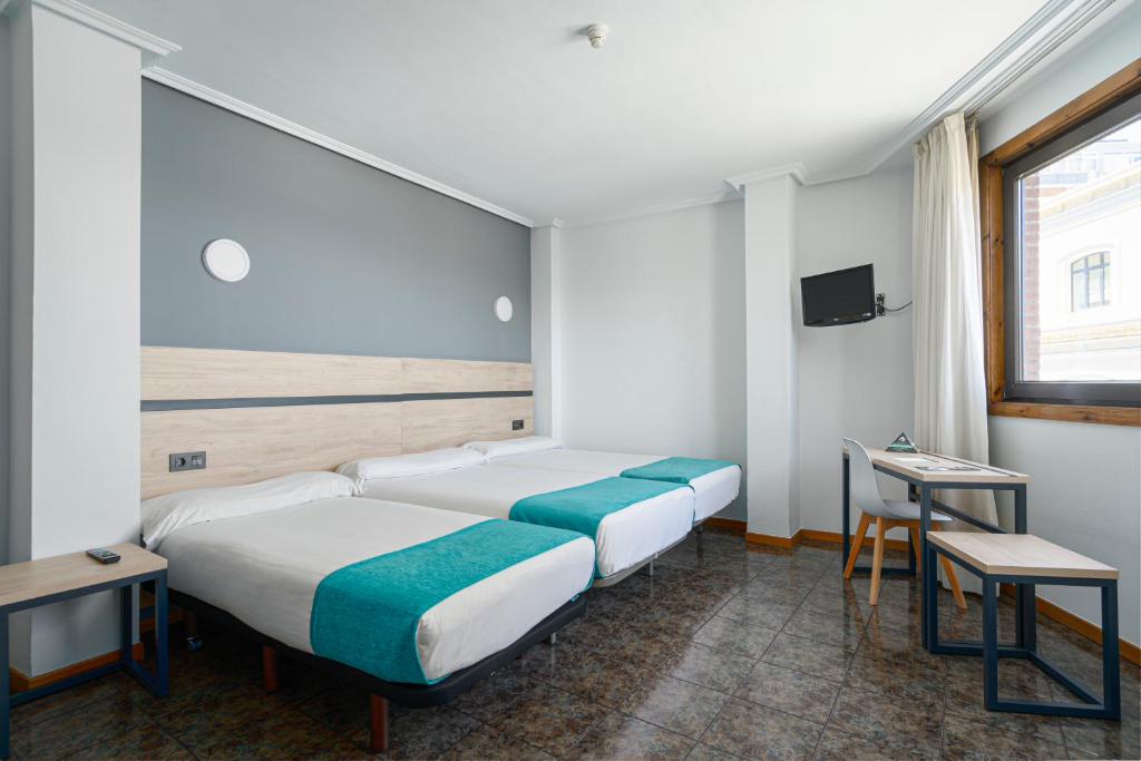 Postel nebo postele na pokoji v ubytování Hotel Alda Pasaje