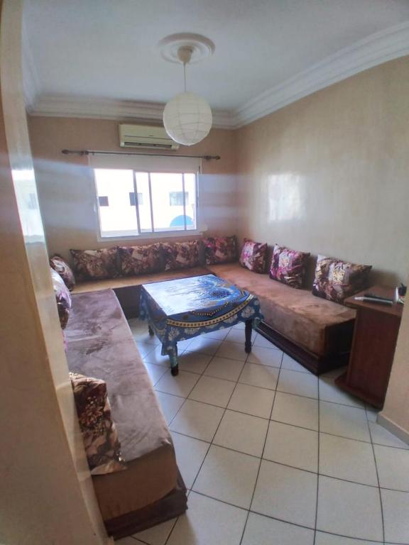 a living room with a couch and a table at Families Apartment in Martil