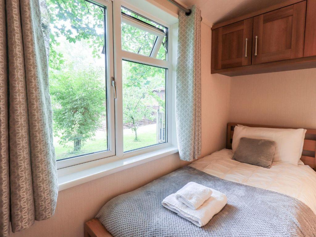 Postel nebo postele na pokoji v ubytování Tiggywinkle Beck Lodge