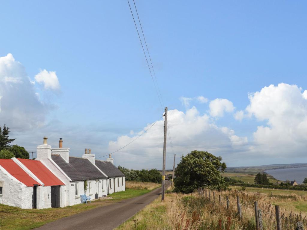 a row of white cottages on the side of a road at Ceol-na-Mara 