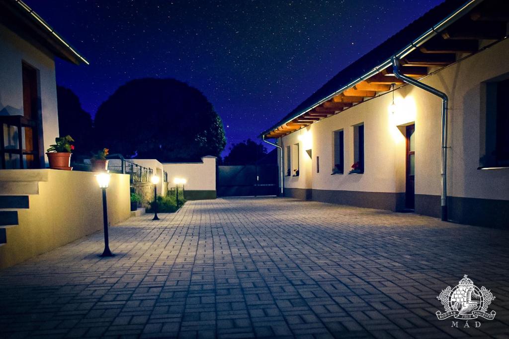 an empty courtyard of a building at night at Érintés Vendégház in Tállya