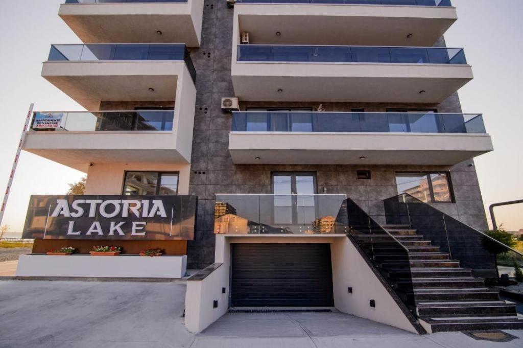 a apartment building with a garage in front of it at Mamaia Nord-Astoria Lake-Studio in Mamaia