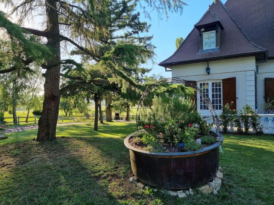 a large wooden planter in front of a house at La Fruitière in Chaudenay