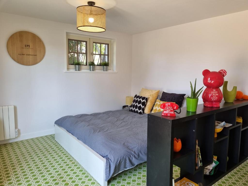 a bedroom with a bed and a shelf with plants at La Fruitière in Chaudenay