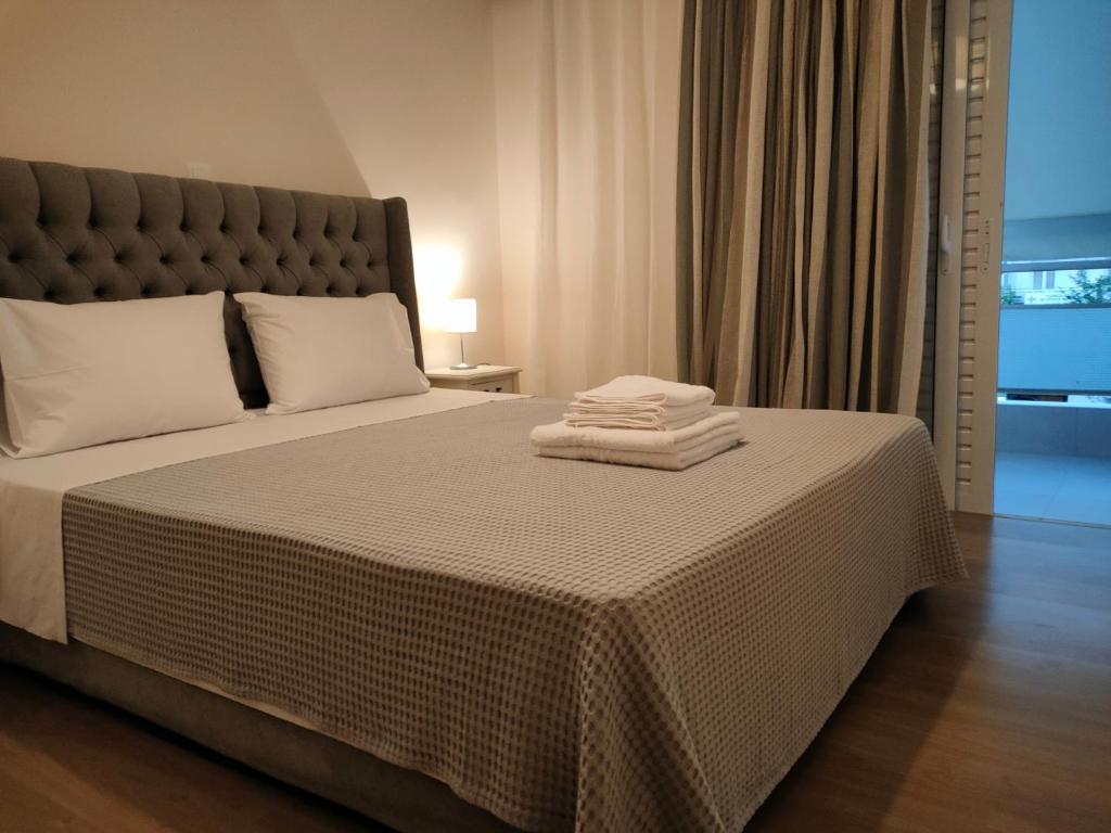 a bedroom with a bed with two towels on it at CA Comfort Living in Kalamata