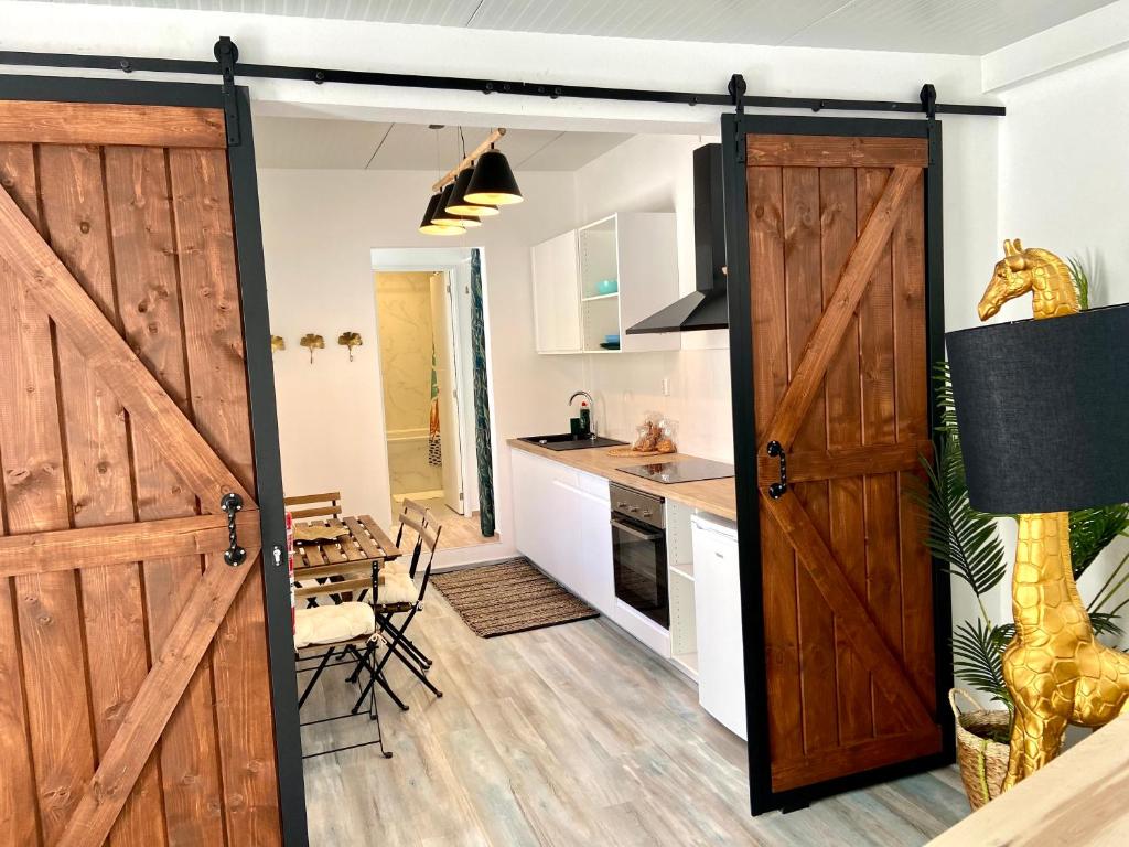 a kitchen with a sliding barn door in a room at CASA SOLE - Apartamento Playa San Juan NR. 4 in Guía de Isora
