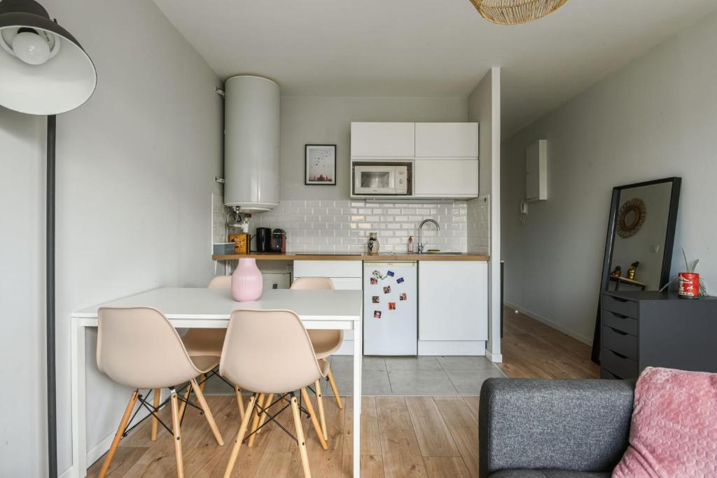 a kitchen and living room with a table and chairs at Beautiful apartment with a balcony in the heart of Lille - Welkeys in Lille