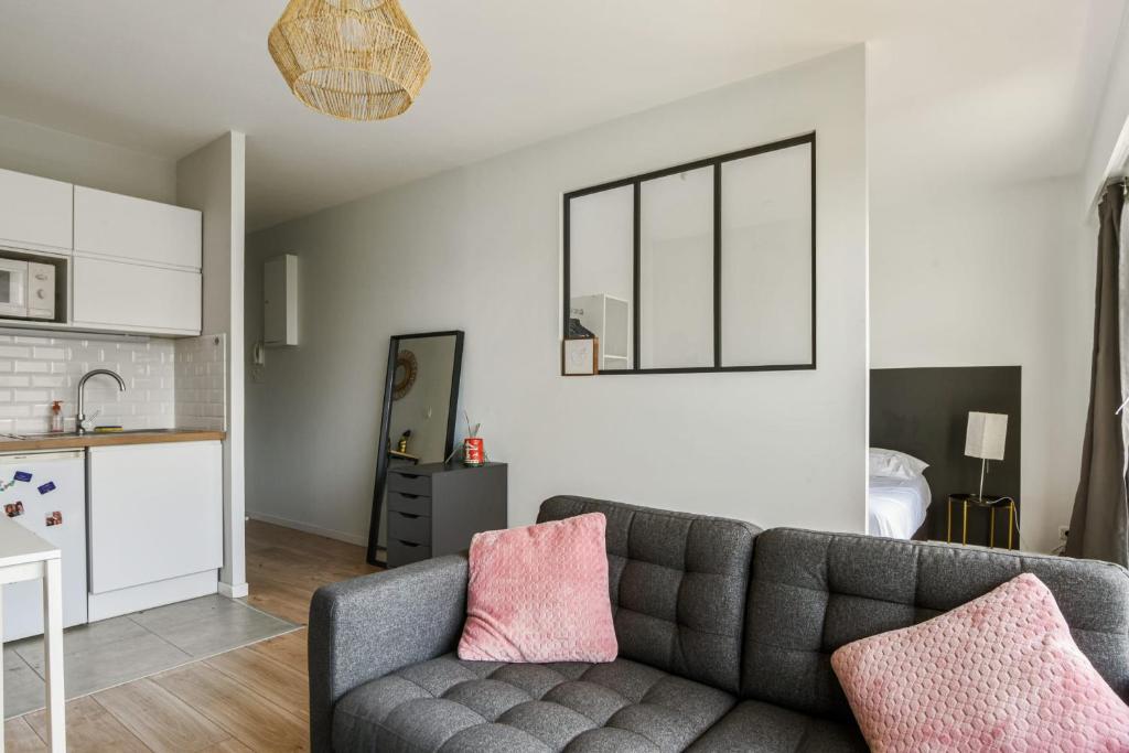 a living room with a couch and a kitchen at Beautiful apartment with a balcony in the heart of Lille - Welkeys in Lille