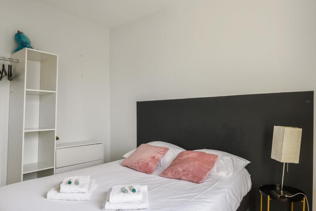 a bedroom with a bed with two towels on it at Beautiful apartment with a balcony in the heart of Lille - Welkeys in Lille