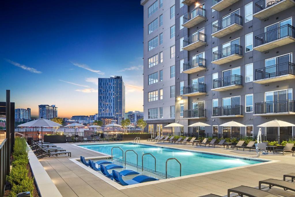 a swimming pool in front of a building at Sentral SoBro in Nashville