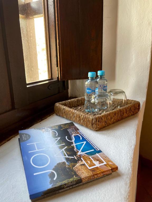 a book and two bottles of water on a counter at Hotel Boutique Posada Las Trampas in Honda