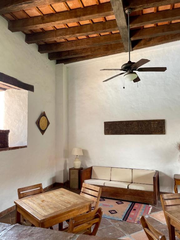 a living room with a couch and a ceiling fan at Hotel Boutique Posada Las Trampas in Honda