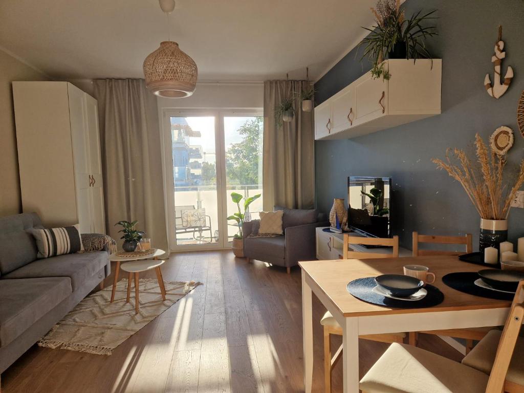 a living room with a couch and a table at Apartament Iławianka in Iława