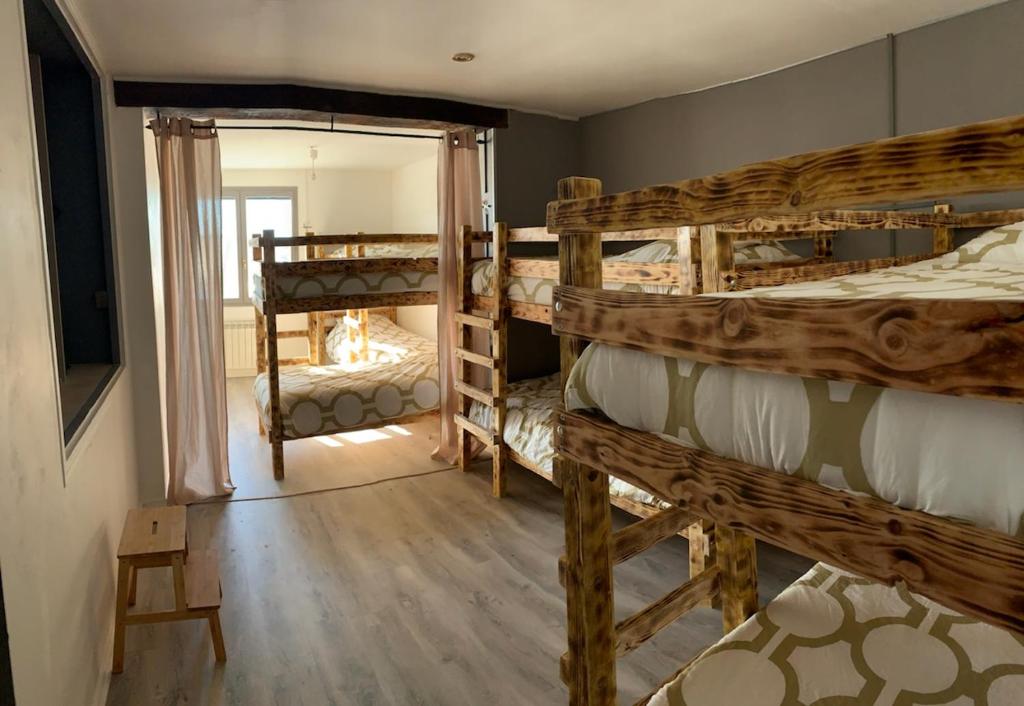 a room with two bunk beds and a mirror at Gîte familial avec spa privatif & piscine chauffée in Belleray