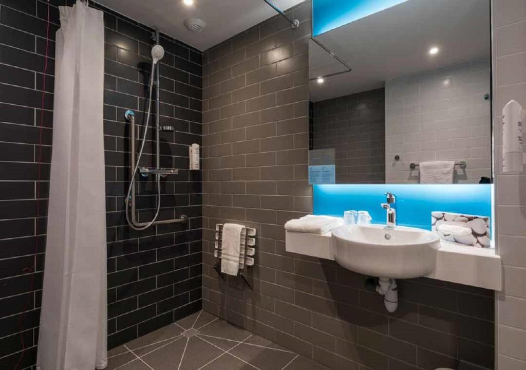 a bathroom with a sink and a shower at Holiday Inn Express - Paris - CDG Airport by IHG in Roissy-en-France
