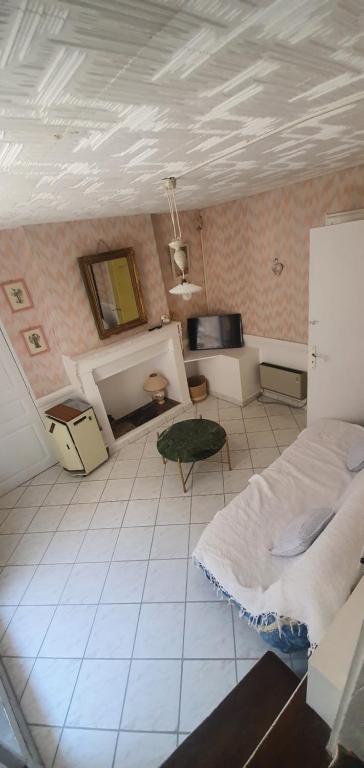 a room with a bed and a fireplace in it at charmante maison de village in Saint-Jean-du-Bruel