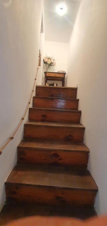 a stairway with wooden steps and a stair case at charmante maison de village in Saint-Jean-du-Bruel