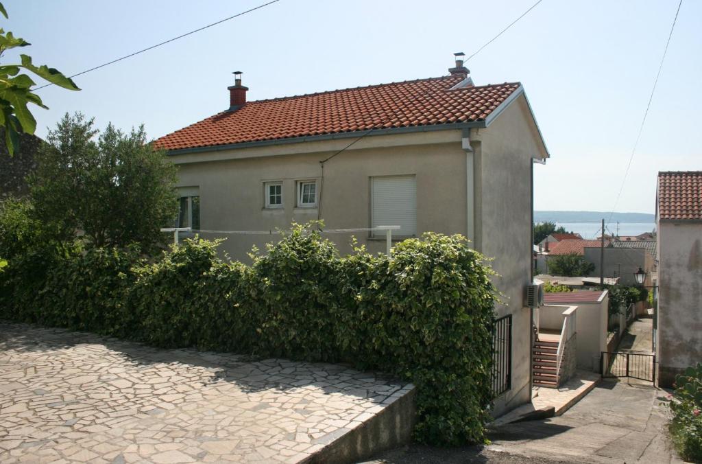 a house with a gate in front of it at Apartments with a parking space Selce, Crikvenica - 5366 in Selce