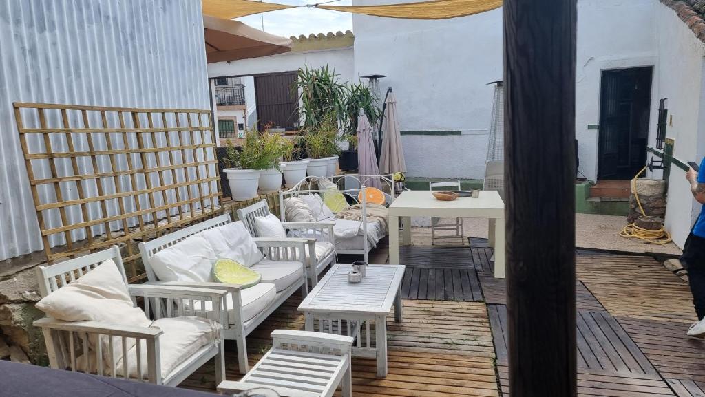 an outdoor patio with couches and tables and a table at Casa Rural La Cruz in El Gordo