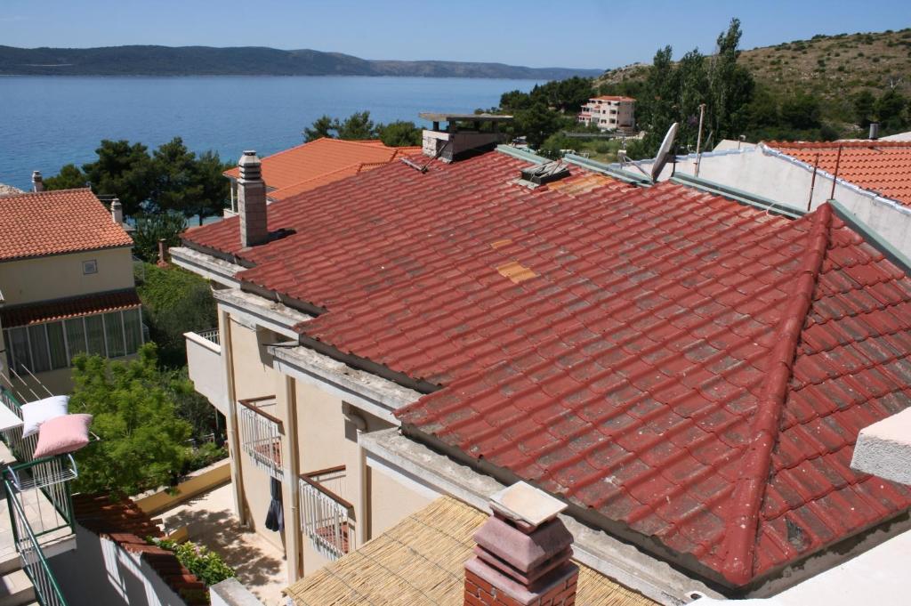 an overhead view of a red roof on a building at Apartments by the sea Zivogosce - Blato, Makarska - 6797 in Igrane