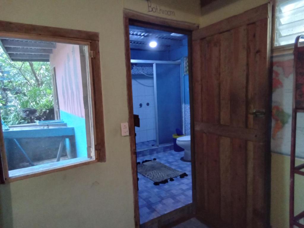 a bathroom with a tub and a toilet and a window at Hostel Del Lago Yojoa Backpackers in Agua Azul