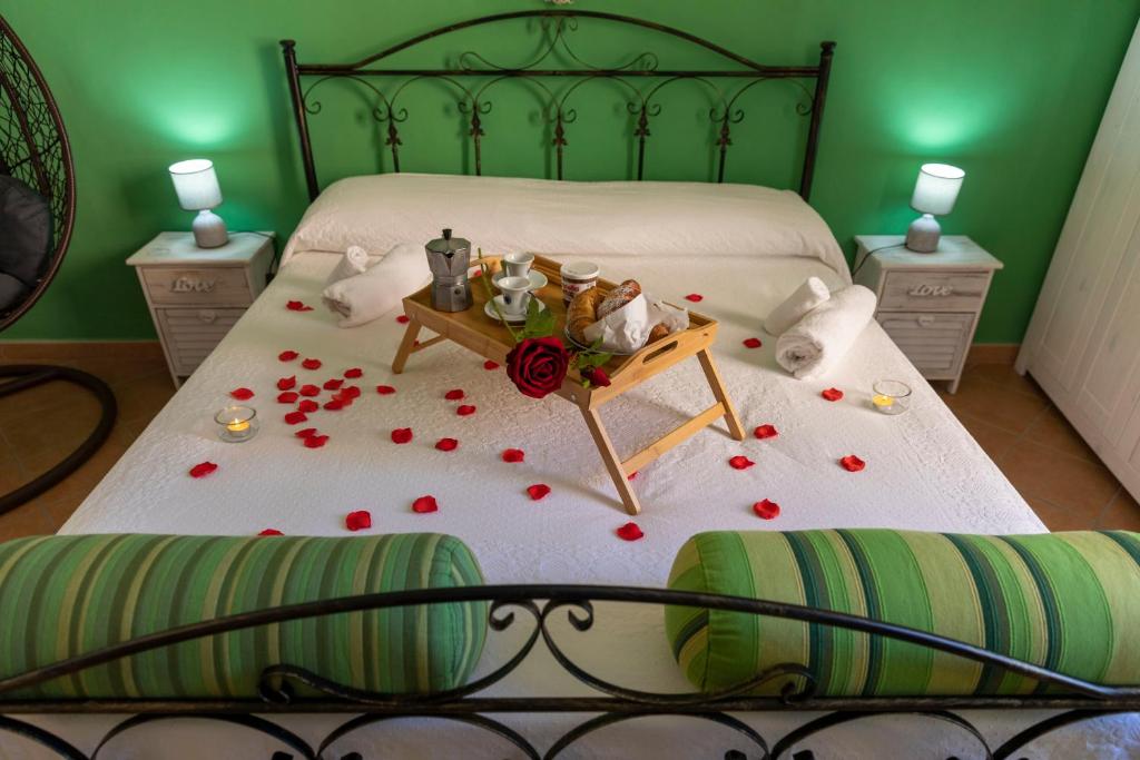 a bedroom with a bed with a table with roses on it at Casa Domitilla Vista Mare - Spiagge, Storia & Relax Wifi - Netflix in Terracina